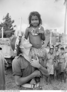 NAURU ISLAND. 1945-09-16. PRIVATE CORFIELD, 31/51ST INFANTRY BATTALION MAKES FRIENDS WITH A YOUNG NAURUAN GIRL SOON AFTER THE UNIT HAD TAKEN OVER THE ISLAND FROM THE JAPANESE