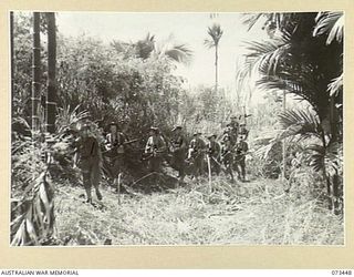 ALEXISHAFEN, NEW GUINEA. 1944-05-18. MEMBERS OF NO.9 PLATOON, A COMPANY, 35TH INFANTRY BATTALION MOVING ALONG A JUNGLE TRACK NEAR YELBECK MISSION TO POSITIONS NORTH OF ALEXISHAFEN. IDENTIFIED ..