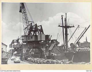 TOWNSVILLE, QLD. 1944-10-18. LOADING OPERATIONS ABOARD THE LIBERTY SHIP SS JAMES OLIVER DURING EMBARKATION OF ELEMENTS OF FIRST ARMY TO LAE, NEW GUINEA