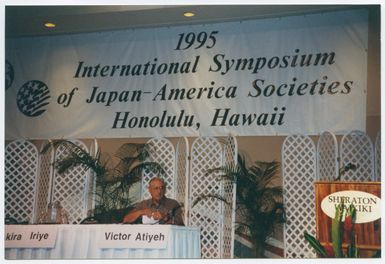 Atiyeh sitting at the table for the Symposium of Japan and America