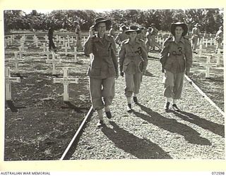 LAE, NEW GUINEA. 1944-04-23. MEMBERS OF THE AUSTRALIAN ARMY NURSING SERVICE FROM THE 2/7TH GENERAL HOSPITAL AMONG PERSONNEL INSPECTING THE LAE WAR CEMETERY AT THE CONCLUSION OF THE DEDICATION ..
