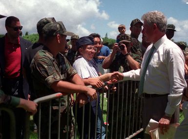 President William Jefferson Clinton shakes hands with Captain Diane Harriel, 15th Communication Squadron as he greets the crowd at the commemoration of the 50th anniversary of World War II