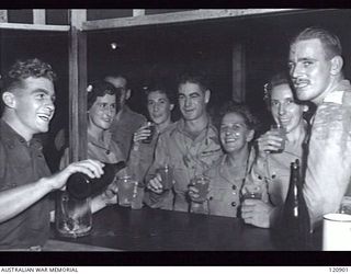 RABAUL, NEW BRITAIN. 1945-12-28. THE PRIME MINISTER OF AUSTRALIA, MR BEN CHIFLEY, ARRIVED BY PLANE TO VISIT MANY OF THE UNITS IN THE AREA. GUESTS AT THE BAR IN THE SISTERS' MESS AT 118TH AUSTRALIAN ..