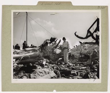 Photograph of Commander Harold G. Belford of Newport Inspecting a Wrecked Japanese Dual-purpose Gun