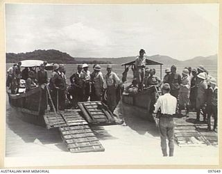 SAMANSO ISLAND, BOUGAINVILLE AREA. 1945-10-01. LIEUTENANT GENERAL M. KANDA AND VICE-ADMIRAL BARON SAMEJIMA STANDING ON THE RAMP OF A JAPANESE BARGE WAITING FOR THE ORDER TO MOVE ASHORE. ALL HIGH ..