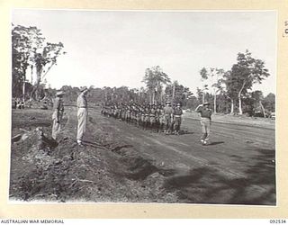 BOUGAINVILLE. 1945-05-23. BRIGADIER J.R. STEVENSON, COMMANDER 11 INFANTRY BRIGADE (1), TAKING THE SALUTE DURING THE MARCH PAST OF A COMPANY, PAPUAN INFANTRY BATTALION, AFTER THEIR ARRIVAL IN THE ..