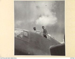 MAPRIK, NEW GUINEA. 1945-10-03. THE PILOT AND OBSERVER ABOARD AN AIRCRAFT ON AN AIRFIELD AT AUSTRALIAN NEW GUINEA ADMINISTRATIVE UNIT HEADQUARTERS AS PLANE PREPARES FOR TAKE OFF