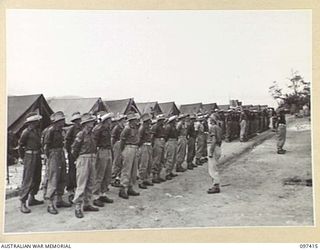 WEWAK POINT, NEW GUINEA. 1945-10-02. MEMBERS OF C COMPANY, 2/3 MACHINE-GUN BATTALION ON PARADE PRIOR TO THE PRESENTATION OF MILITARY MEDALS TO SERGEANT E. HAYLETT AND CORPORAL G.A. LAMBERT, MEMBERS ..