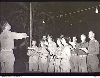 RABAUL, NEW BRITAIN, 1945-12-18. CHOIR PRACTICE IN PROGRESS AT NONGA, THE AUSTRALIAN ARMY EDUCATION SERVICE CENTRE. THE CHOIR, WHICH INCLUDES MEMBERS OF THE WOMEN'S SERVICES, TAKE THEIR PRACTICE ..