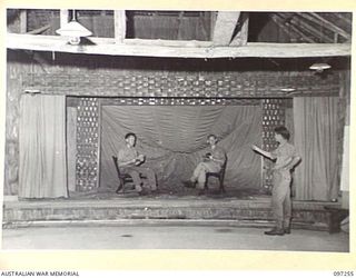 LAE, NEW GUINEA. 1945-09-11. MEMBERS OF THE CHARING CROSS PLAY READING GROUP ATTENDING A REHEARSAL AT THE CHARING CROSS EDUCATION CENTRE