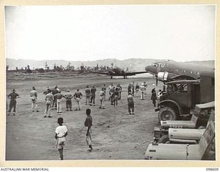 RABAUL, NEW BRITAIN. 1945-10-30. THE BUSY SCENE AS THE MAIL PLANE, A DOUGLAS C47 DAKOTA ARRIVES AT LAKUNAI AIRSTRIP WHICH IS SITUATED NEAR MATUPI CRATER