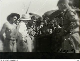 AITAPE, NORTH EAST NEW GUINEA. C. 1944-06. ARTHUR DRAKEFORD, THE MINISTER FOR AIR, TALKING TO RAAF AIRMEN IN FRONT OF A BEAUFIGHTER AIRCRAFT OF NO. 30 SQUADRON RAAF ON THE TADJI AIRSTRIP DURING A ..