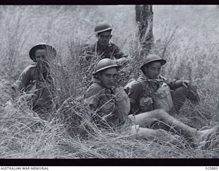 PORT MORESBY, PAPUA, 1942-07-11. AUSTRALIAN INFANTRY CONDUCTING MANOEUVRES IN DENSE TROPICAL BUSH IN NEW GUINEA. HERE SOME OF THE TROOPS ARE RESTING DURING A BREAK IN THE EXERCISE