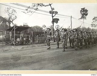 BOUGAINVILLE ISLAND. 1945-01-30. PERSONNEL OF THE 266TH LIGHT AID DETACHMENT GIVE EYES RIGHT TO VX13 LIEUTENANT GENERAL S.G. SAVIGE, CB, CBE, DSO, MC, ED, GENERAL OFFICER COMMANDING, 2ND AUSTRALIAN ..