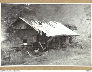 KAKAKOG AREA, NEW GUINEA, 1943-10-02. A HOUSE DAMAGED BY ALLIED BOMBER RAIDS