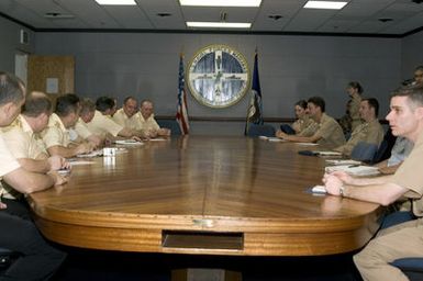 Officers of the US Navy (USN) and Russian Federated Navy (RFN) talk at the exercise brief for passing Exercise (PASSEX) 06 at Naval Base (NB) Guam (GU). PASSEX 06 is an exercise designed to increase interoperability between the two navies while enhancing the strong cooperative relationship between Russia and the United States