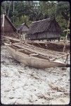 Canoes on the beach at Wawela village, houses in background