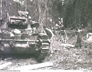 THE SOLOMON ISLANDS, 1945-04-24/27. MATILDA TANKS OF 2/4TH AUSTRALIAN ARMOURED REGIMENT WITH THEIR CREW MEMBERS PREPARING A CAMP SITE ON BOUGAINVILLE ISLAND. (RNZAF OFFICIAL PHOTOGRAPH.)