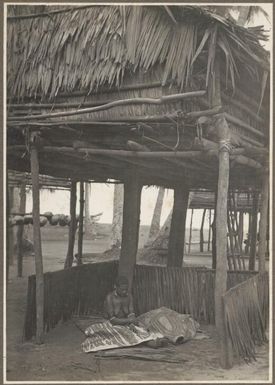 Funeral ceremony, Wanigella [Wanigela], [a woman sitting under a shelter with a body covered by cloth next to her] Frank Hurley