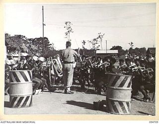 LAE AREA, NEW GUINEA. 1945-08-04. THE ROYAL PAPUAN CONSTABULARY BAND ENTERTAINING PATIENTS AT 2/7 GENERAL HOSPITAL DURING THE ARTS AND CRAFTS EXHIBITION WHICH WAS HELD AT THE RED CROSS SOCIETY HUT