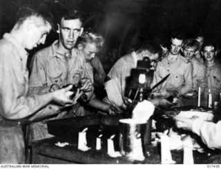 New Guinea. 1944. Members of an RAAF Beaufort Squadron being served with grilled steak at a barbecue and concert. Proceeds were donated to the family of a young navigator who failed to return from ..