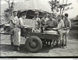 NADZAB, NEW GUINEA. C. 1944-02. AT NO. 24 MEDICAL CLEARING STATION RAAF A JEEP HAULS A TRAILER ROUND THE TENT WARDS WITH FOOD FOR THE PATIENTS AT LUNCH TIME