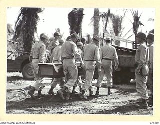 JACQUINOT BAY, NEW BRITAIN. 27 FEBRUARY 1945. TROOPS OF THE B COMPANY 594TH ENGINEER BOAT AND SHORE REGIMENT, UNITED STATES ARMY, CARRYING THE REMAINS OF PRIVATE P. FANNIN TO THE FUNERAL TRUCK
