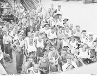 LAE, NEW GUINEA. 1944-11-02. PERSONNEL OF THE 14/32N INFANTRY BATTALION ON THE DECK OF THE TROOPSHIP, "CAPE ALEXANDER" WITH THEIR DOG MASCOT, VX00 STINKER. IDENTIFIED PERSONNEL ARE:- VX118095 ..