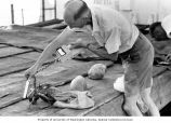 Kelshaw Bonham taking radiation readings from a crab from various angles, Bikini Atoll, Summer 1964