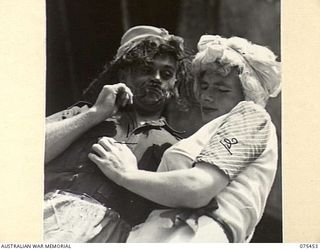 MILILAT, NEW GUINEA. 1944-08-23. COMEDIANS OF THE "TASMANIACS", THE TASMANIAN LINES OF COMMUNICATION CONCERT PARTY REHEARSING THEIR SKETCH, "RUSSIAN EMIGRANTS AND THE GIRL" IN PREPARATION FOR THE ..