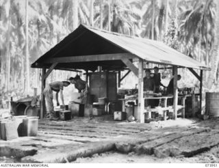 MADANG, NEW GUINEA. 1944-06-17. MEMBERS OF THE KITCHEN STAFF OF HEADQUARTERS COMPANY, 58/59TH INFANTRY BATTALION AT WORK. THE UNIT IS LOCATED AT SIAR PLANTATION. LEFT TO RIGHT: V45765 PRIVATE (PTE) ..