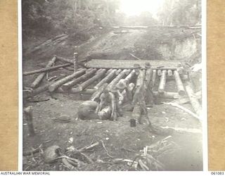 FINSCHHAFEN AREA, NEW GUINEA. 1943-11-11. TROOPS OF THE 2/3RD AUSTRALIAN PIONEER BATTALION BUILDING A BRIDGE ACROSS A CREEK ON THE NEW ROAD BETWEEN SCARLET BEACH AND SIMBANG