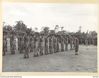 TOROKINA, BOUGAINVILLE. 1945-10-06. TROOPS OF 24 INFANTRY BATTALION OBSERVING ONE MINUTE'S SILENCE DURING THE COMMEMORATIVE SERVICE AT THE TOROKINA WAR CEMETERY IN MEMORY OF MEN WHO DIED IN THE ..