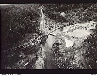 HONGORAI RIVER AREA, BOUGAINVILLE ISLAND. 1945-07-28. LOOKING EAST, PHOTOGRAPH TAKEN BY NO. 5 SQUADRON, RAAF, OF THE BRIDGE OVER THE HONGORAI RIVER, CONSTRUCTED BY ROYAL AUSTRALIAN ENGINEERS. ..