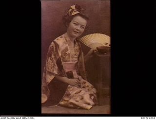 Sydney, NSW, c 1947. Hand tinted portrait of Patricia Finnigan wearing a traditional Japanese kimono sent to her from Japan by her father NX94709 Private W.J. Finnigan when he served in BCOF. ..