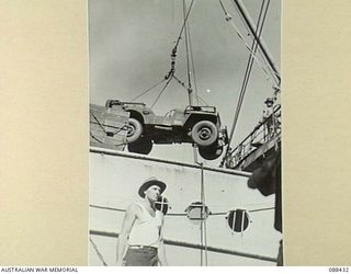 CAIRNS, QUEENSLAND. 1945-03-25. A HEADQUARTERS 26 INFANTRY BRIGADE JEEP IS LOADED ABOARD THE DUTCH VESSEL VAN HEUTSZ DURING EMBARKATION TO MILNE BAY