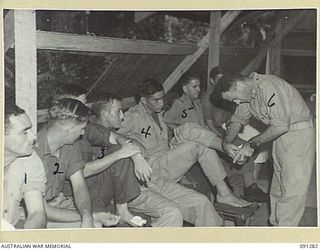 VX144798 PRIVATE WILLIAM RAYMOND BLOCK, 26 INFANTRY BATTALION (4), AT THE REGIMENTAL AID POST, 2/3 CONVALESCENT DEPOT, HAS A FOOT DRESSING APPLIED BY PRIVATE O.W. SEIDEL, REGIMENTAL AID POST ..