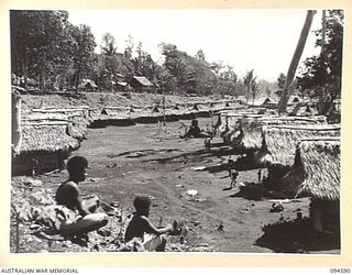 SIPILANGAN, NEW BRITAIN, 1945-07-27. THE LIVING QUARTERS OF REFUGEE NATIVES AT THE AUSTRALIAN NEW GUINEA ADMINISTRATIVE UNIT REFUGEE CAMP IN THE WIDE BAY AREA ALONG THE BEACH. THE LINES ARE KEPT ..