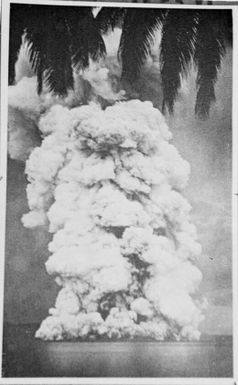 Photograph of a photograph of eruption with a fringe of palm leaves across the top, Rabaul, New Guinea, 1937 / Sarah Chinnery