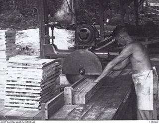 LAE, NEW GUINEA. 1945-12. DOCKING SAW IN THE SAW MILL AT 4TH ADVANCED ORDNANCE DEPOT. (DONOR: J. W. K. BEDDOME)