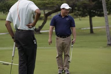 Barack Obama plays golf with Prime Minister Najib Razak, Joe Paulsen, and Mike Brush in Kaneohe Bay, Hawaii, December 24, 2014