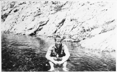 Jack Arden sitting in the water, New Caledonia, 1942