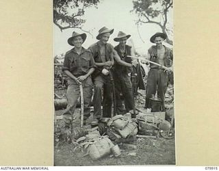 DAGUA, NEW GUINEA. 1945-03-25. TROOPS OF THE 2/2ND INFANTRY BATTALION DISPLAY AN ARRAY OF CAPTURED JAPANESE SWORDS. IDENTIFIED PERSONNEL ARE:- QX31236 PRIVATE D.R. DAY (1); NX21119 PRIVATE A. WEBB ..