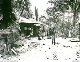 THE SOLOMON ISLANDS, 1945-10-12. NATIVES TAKING OVER A FORMER JAPANESE CAMP AREA ON BOUGAINVILLE ISLAND. (RNZAF OFFICIAL PHOTOGRAPH.)