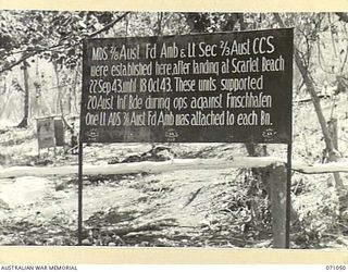 FINSCHHAFEN AREA, NEW GUINEA. 1944-03-13. THE SIGN INDICATING THE POINT OF ESTABLISHMENT OF THE MEDICAL DRESSING STATION, 2/8TH FIELD AMBULANCE AND THE LIGHT SECTION OF THE 2/3RD CASUALTY CLEARING ..