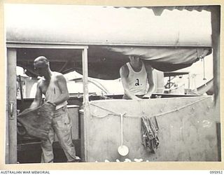 BORAM BEACH, WEWAK AREA, NEW GUINEA. 1945-08-31. CORPORAL S.J. WESCOTT (1) AND PRIVATE S.H. WHYTE (2), MEMBERS OF 2/15 FIELD AMBULANCE WORKING THE MOBILE COOKER