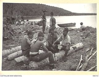 MUSCHU ISLAND, NEW GUINEA. 1945-09-11. GROUP OF JAPANESE SOLDIERS HAVING THEIR MID-DAY MEAL. THE ISLAND IS NOW OCCUPIED BY HEADQUARTERS 6 DIVISION AND THE JAPANESE ARE ENGAGED ON BUILDING HOSPITAL ..