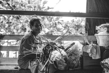 Black and white image of woman with crafted fan, Fakaofo, Tokelau