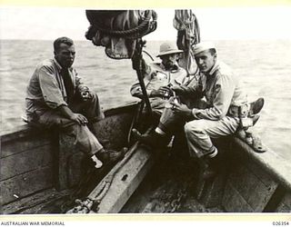 NEW GUINEA. 1942-08-03. THREE AMERICAN SOLDIERS TAKING THINGS EASY ON THE BOW OF A SMALL CRAFT ..