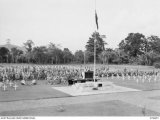 LAE, NEW GUINEA. 1944-11-05. NX369 CHAPLAIN P. T. BOLAND, ASSISTANT CHAPLAIN GENERAL, (ROMAN CATHOLIC) ASSISTED BY VX135323 PRIVATE G. G. MEREDITH, CELEBRATING A SOLEMN REQUIEM MASS AT THE ALTAR ON ..